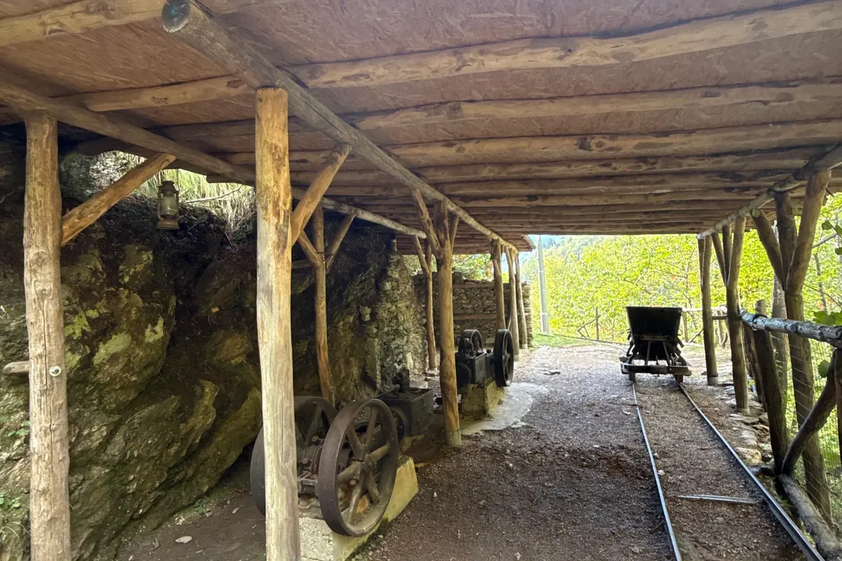 Tettoia esterna con i macchinari minerari originali e il carrello sui binari